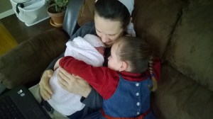 Snuggling with my littlest and the new big sister 